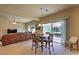 Open dining area with a glass table and sliding doors leading to the outdoor space and living room at 2373 Rue Royale St, Henderson, NV 89044