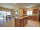 An open eat-in kitchen is bright with natural light and features an island and tile flooring at 2373 Rue Royale St, Henderson, NV 89044