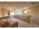 A loft is carpeted, features a ceiling fan, lots of windows, and provides plenty of room for relaxing at 2373 Rue Royale St, Henderson, NV 89044