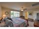 A spacious main bedroom has a ceiling fan, windows, and an attached bathroom at 2373 Rue Royale St, Henderson, NV 89044