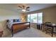 Main bedroom with neutral paint, carpet, a ceiling fan and a large window with privacy blinds at 2373 Rue Royale St, Henderson, NV 89044
