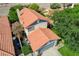 Aerial view of a well-maintained home featuring mature landscaping and a gray driveway leading to a two-car garage at 2412 Muirfield Ave, Henderson, NV 89074