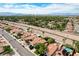 Scenic aerial view of a suburban community with tree-lined streets and mature landscaping, overlooking a green belt at 2412 Muirfield Ave, Henderson, NV 89074