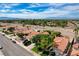 Bird's-eye view showcasing a residential area with verdant trees, swimming pools, and manicured lawns at 2412 Muirfield Ave, Henderson, NV 89074