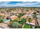 An aerial perspective of a well-maintained suburban community with lush greenery and mature palm trees at 2412 Muirfield Ave, Henderson, NV 89074