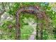 Backyard garden view with an iron garden gate and lush landscaping at 2412 Muirfield Ave, Henderson, NV 89074