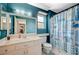 Bright bathroom features a white vanity with a single sink and a shower with a themed blue curtain at 2412 Muirfield Ave, Henderson, NV 89074