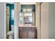 Well-lit bathroom features a vanity with dark wood cabinetry, a mirror, and a toilet near a shower at 2412 Muirfield Ave, Henderson, NV 89074
