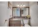 Well-lit bathroom featuring a vanity and a framed mirror at 2412 Muirfield Ave, Henderson, NV 89074