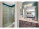 Cozy bathroom features a shower with glass doors, vanity with dark wood cabinets, and a mirror at 2412 Muirfield Ave, Henderson, NV 89074