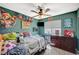 Vibrant bedroom with fun decorations, a ceiling fan, and a comfortable bed, perfect for a  at 2412 Muirfield Ave, Henderson, NV 89074