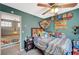 Vibrant bedroom with toys, a bed with stuffed animals, and a view of the hallway, designed for a  at 2412 Muirfield Ave, Henderson, NV 89074