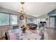 Cozy dining area featuring a chandelier, table with chairs, and access to living room and workstation at 2412 Muirfield Ave, Henderson, NV 89074