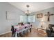 Inviting dining area featuring wood floors, bright window, and a charming chandelier at 2412 Muirfield Ave, Henderson, NV 89074