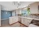 Bright kitchen with modern appliances, white cabinetry, and a view of the dining area at 2412 Muirfield Ave, Henderson, NV 89074