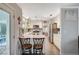 Open concept kitchen with updated appliances, breakfast bar, and wood floors at 2412 Muirfield Ave, Henderson, NV 89074