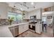 Bright kitchen featuring stainless appliances, stylish backsplash, and natural light at 2412 Muirfield Ave, Henderson, NV 89074