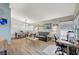 Bright living room featuring wood floors, neutral walls, and a comfortable seating area with a workstation at 2412 Muirfield Ave, Henderson, NV 89074