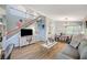 Cozy living room featuring wood floors, staircase, television, and an adjacent dining area with a chandelier at 2412 Muirfield Ave, Henderson, NV 89074