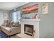 Comfortable living room with a fireplace, couch, and tasteful decorations creating a cozy atmosphere at 2412 Muirfield Ave, Henderson, NV 89074