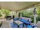 This covered patio features an outdoor seating area with a grill and garden views at 2412 Muirfield Ave, Henderson, NV 89074