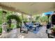 Covered patio space with comfortable outdoor furniture and a lush garden view, ideal for relaxation at 2412 Muirfield Ave, Henderson, NV 89074