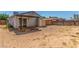 View of a large dirt backyard with a small wooden deck and fenced perimeter at 2432 Spanish Ct, Las Vegas, NV 89108