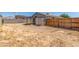 Image of a large dirt backyard with a wooden fence and shed at 2432 Spanish Ct, Las Vegas, NV 89108