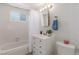 The well-lit bathroom features a tub/shower combo and single sink vanity at 2432 Spanish Ct, Las Vegas, NV 89108