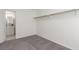This cozy bedroom features neutral carpet, light walls, and a closet for ample storage at 2432 Spanish Ct, Las Vegas, NV 89108