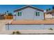 Quaint home with a well-kept lawn and simple landscaping, set against a clear blue sky at 2432 Spanish Ct, Las Vegas, NV 89108