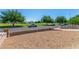 Expansive front yard featuring low-maintenance landscaping and mature trees in a serene neighborhood setting at 2432 Spanish Ct, Las Vegas, NV 89108