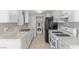 Bright kitchen with white cabinets, granite countertops, stainless steel sink and a gas range at 2432 Spanish Ct, Las Vegas, NV 89108