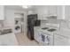 Well-lit kitchen with sleek white cabinets, modern appliances, and durable countertops at 2432 Spanish Ct, Las Vegas, NV 89108