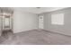 Open living room with carpet, front door, and bright window at 2432 Spanish Ct, Las Vegas, NV 89108
