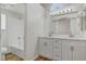 This bathroom is well lit and features dual sinks and a shower-tub combo at 2573 Rafferty Creek Ln, Las Vegas, NV 89156