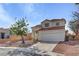 Charming two-story home featuring a red tile roof, a well-maintained yard, and an attached two-car garage at 2573 Rafferty Creek Ln, Las Vegas, NV 89156