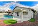 Backyard featuring a covered patio, refreshing pool, and beautiful landscaping, ideal for relaxation at 2714 Langlade Ave, Henderson, NV 89052