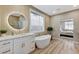 Modern bathroom featuring a soaking tub, marble countertops, and modern fixtures at 2714 Langlade Ave, Henderson, NV 89052