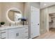 Elegant bathroom with vanity, glass shower, and walk-in closet access at 2714 Langlade Ave, Henderson, NV 89052