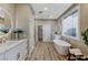Modern bathroom with a soaking tub, double vanity, and stylish fixtures at 2714 Langlade Ave, Henderson, NV 89052