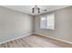Bright bedroom with light-colored, hard-surface floors and decorative light fixture at 2714 Langlade Ave, Henderson, NV 89052