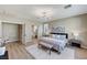 Spacious bedroom features a sitting bench, neutral decor, and ensuite bathroom access at 2714 Langlade Ave, Henderson, NV 89052