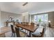 Formal dining area with a rustic wood table, elegant chandelier, and comfortable upholstered chairs and bright natural light at 2714 Langlade Ave, Henderson, NV 89052