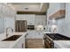 Well-lit kitchen equipped with stainless steel appliances, granite countertops, and ample cabinet space at 2714 Langlade Ave, Henderson, NV 89052