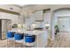Gourmet kitchen with waterfall island, marble countertops, stainless steel appliances, and custom cabinetry at 2714 Langlade Ave, Henderson, NV 89052
