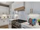 Close-up of a modern kitchen featuring white cabinets, quartz countertops, and a gourmet stovetop at 2714 Langlade Ave, Henderson, NV 89052