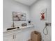 Functional laundry room with sink, cabinets, and quirky wall art at 2714 Langlade Ave, Henderson, NV 89052