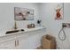 Functional laundry room showcasing a sink, modern white cabinets, and charming decor at 2714 Langlade Ave, Henderson, NV 89052