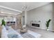 Open-concept living area flows into a modern kitchen, featuring sleek furnishings and a cozy fireplace at 2714 Langlade Ave, Henderson, NV 89052